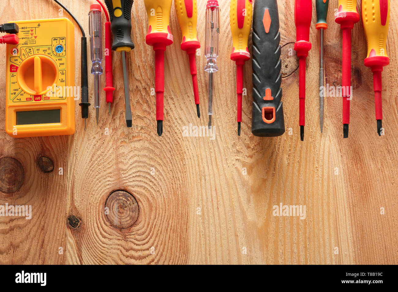 Different electrician's tools on wooden background Stock Photo