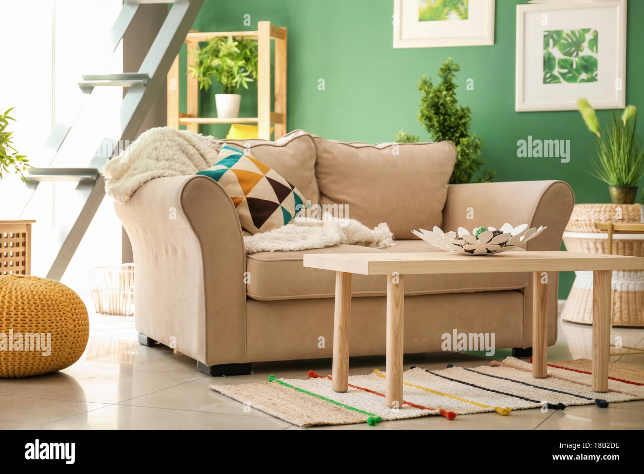 Modern interior of living room with comfortable sofa and wooden table ...