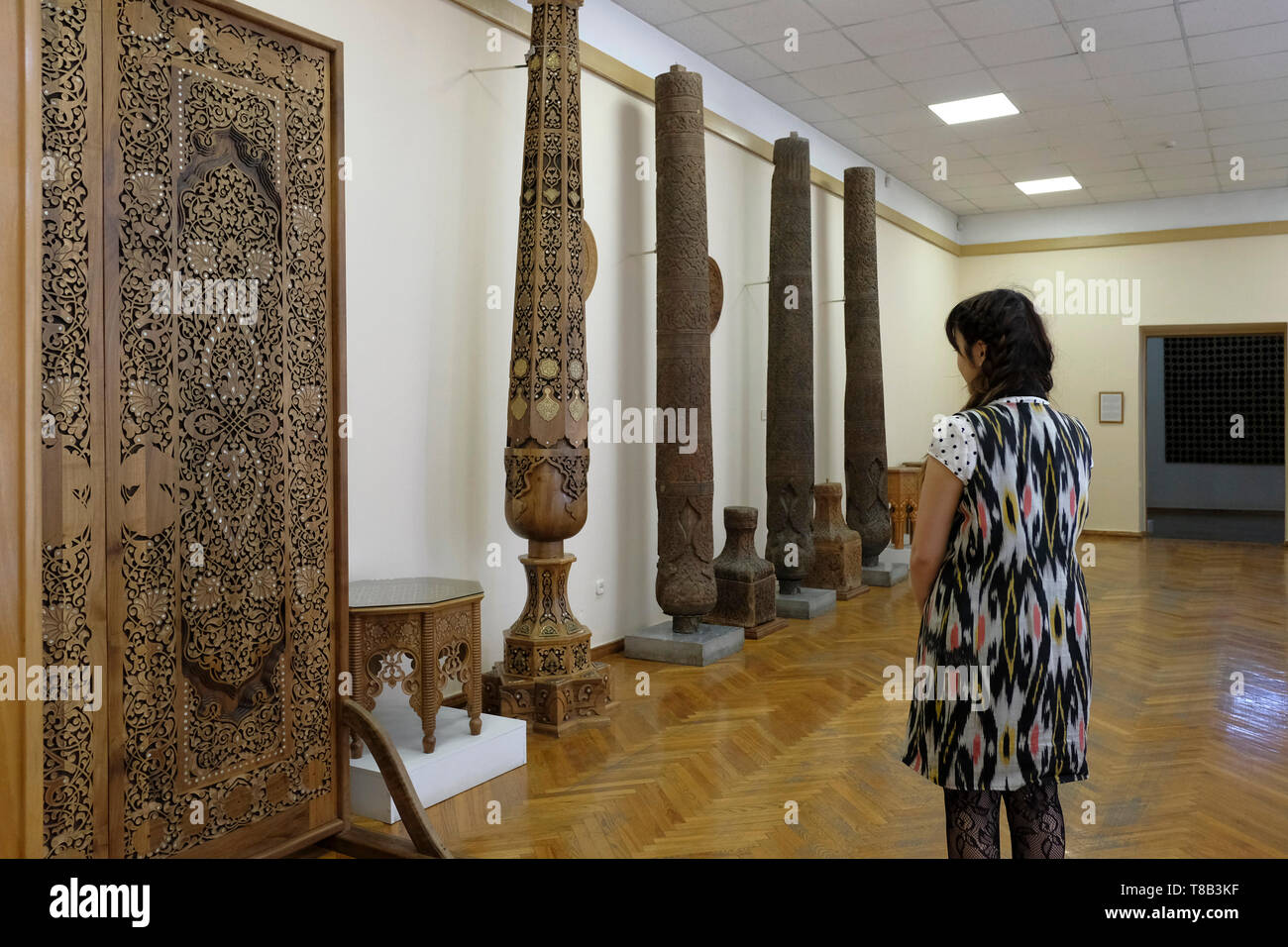 A visitor looking at ornately carved wood displayed at the Museum of Applied Arts situated in the former home of Imperial Russian diplomat Alexander Polovtsev in the city of Tashkent capital of Uzbekistan Stock Photo