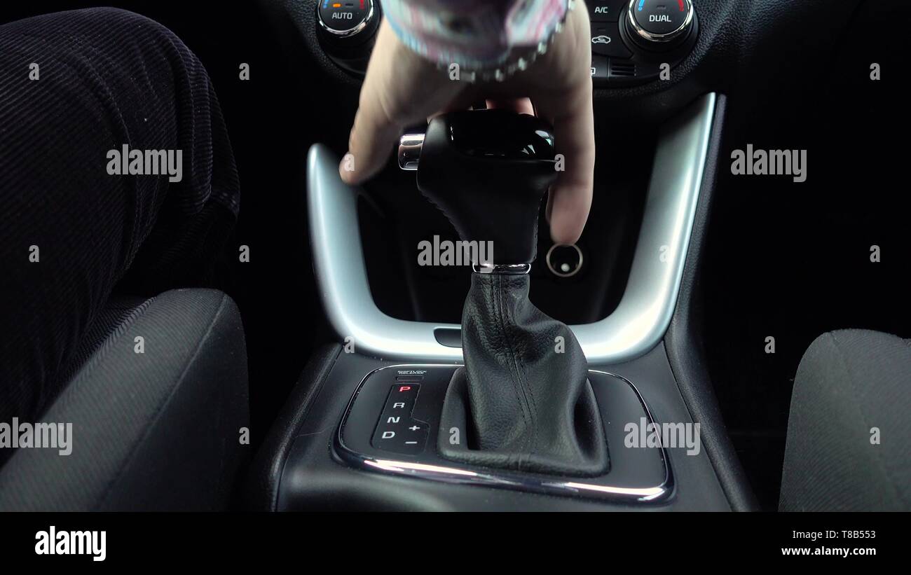 Man shifting gear, Close up of hand on automatic modern gear Stock