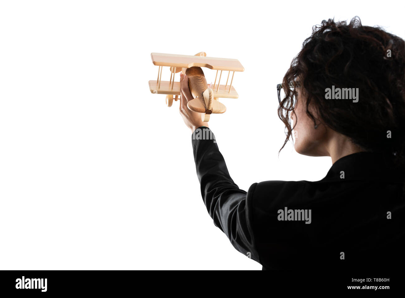 Businesswoman play with a toy aircraft. Concept of company startup and business success. Isolated on white background. Stock Photo