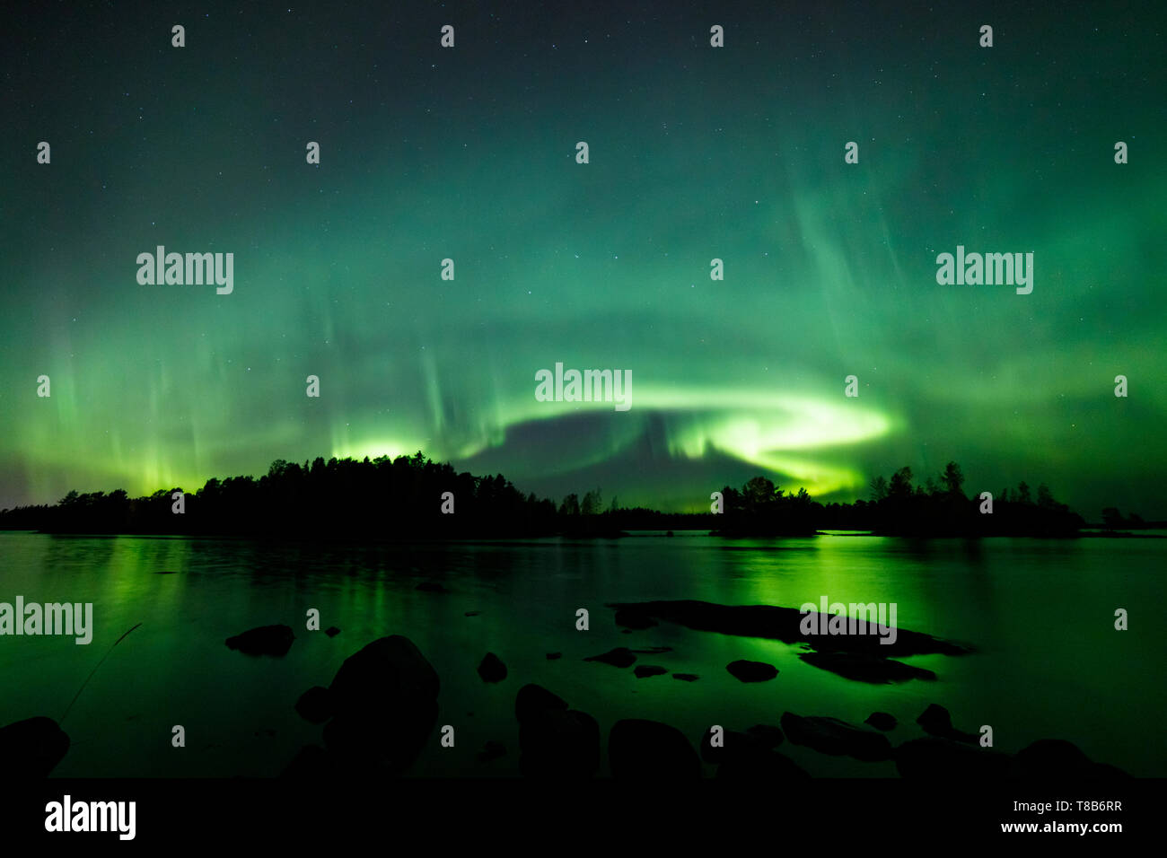 Beautiful northern lights over lake Stock Photo - Alamy