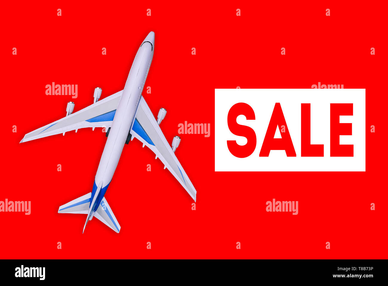 Passenger aircraft on a red background. Sale of air tickets and travel vouchers. Advertising banner and discount. Travel and tourism concept Stock Photo