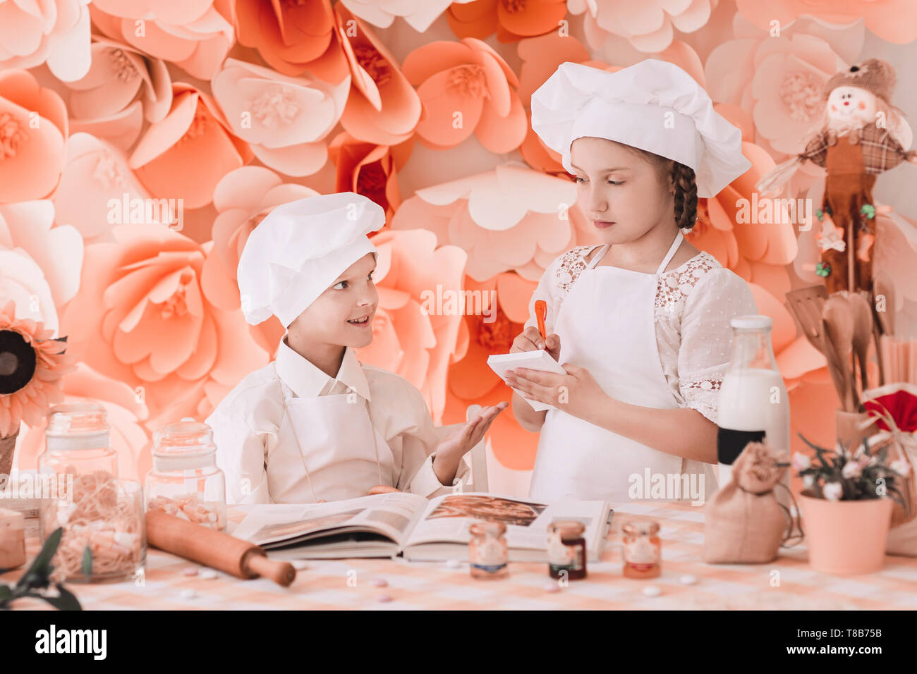 Brother And Sister In Uniform Chefs Record Menu Standing At The