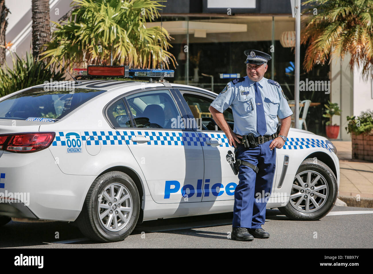New South Wales police man stood by his police car in Sydney,NSW, Australia Stock Photo