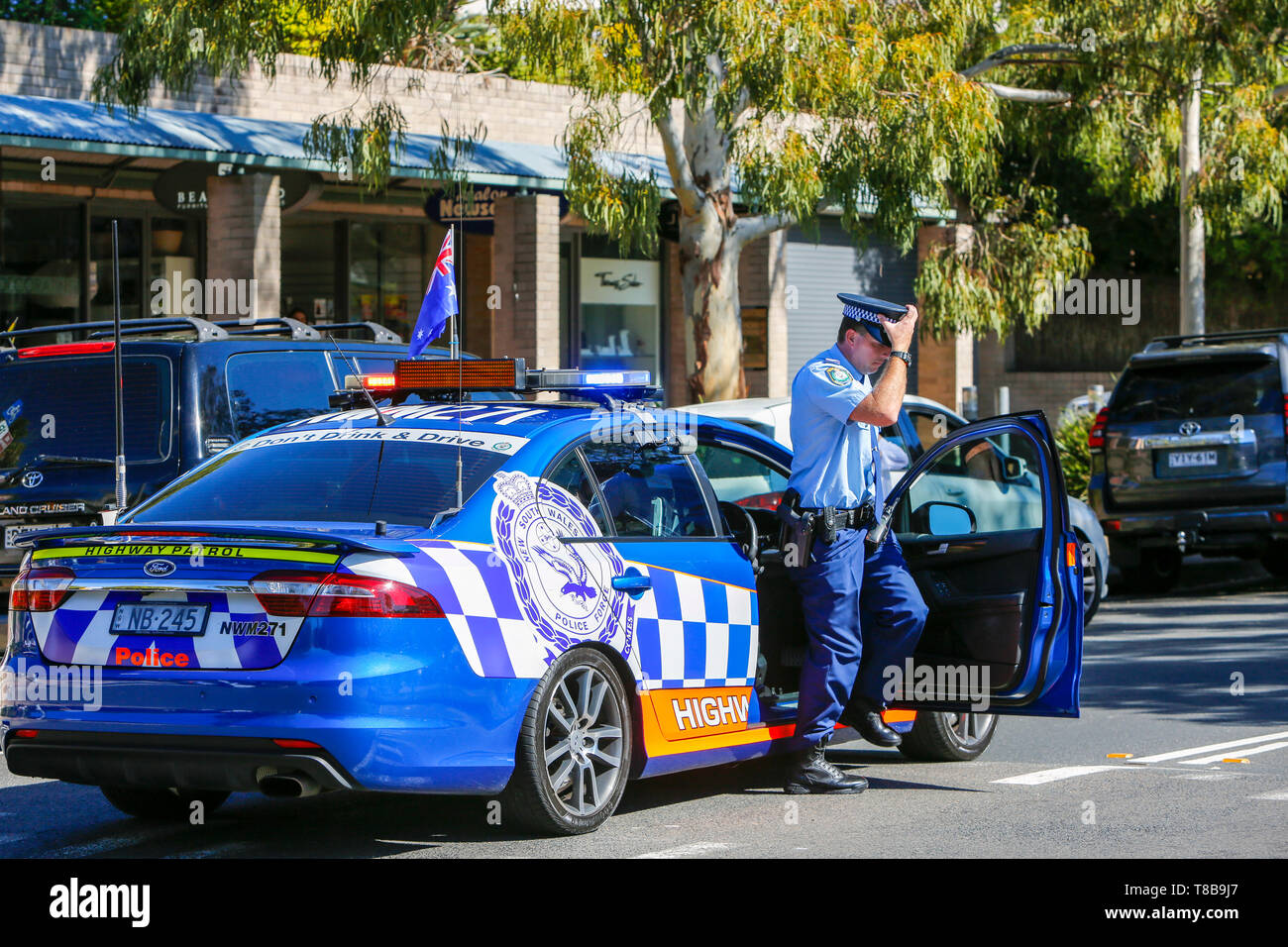 Australian police officer in Highway Patrol police car at an ANZAC Day march in Sydney,NSW, Australia Stock Photo