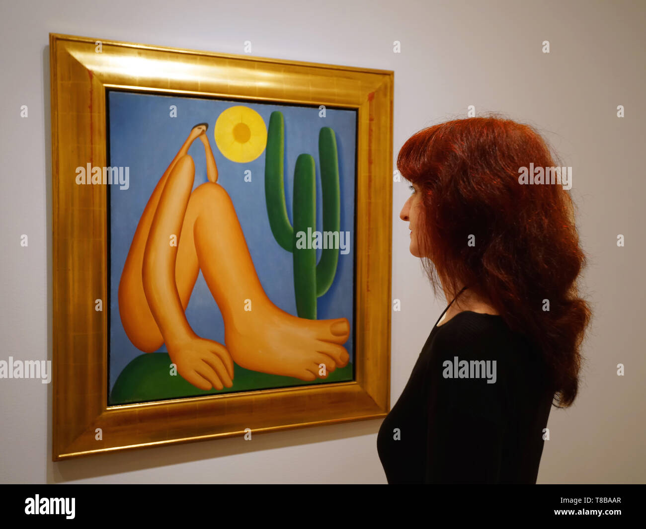 A woman looking at oil painting 'Abaporu' by Tarsila do Amaral. Stock Photo