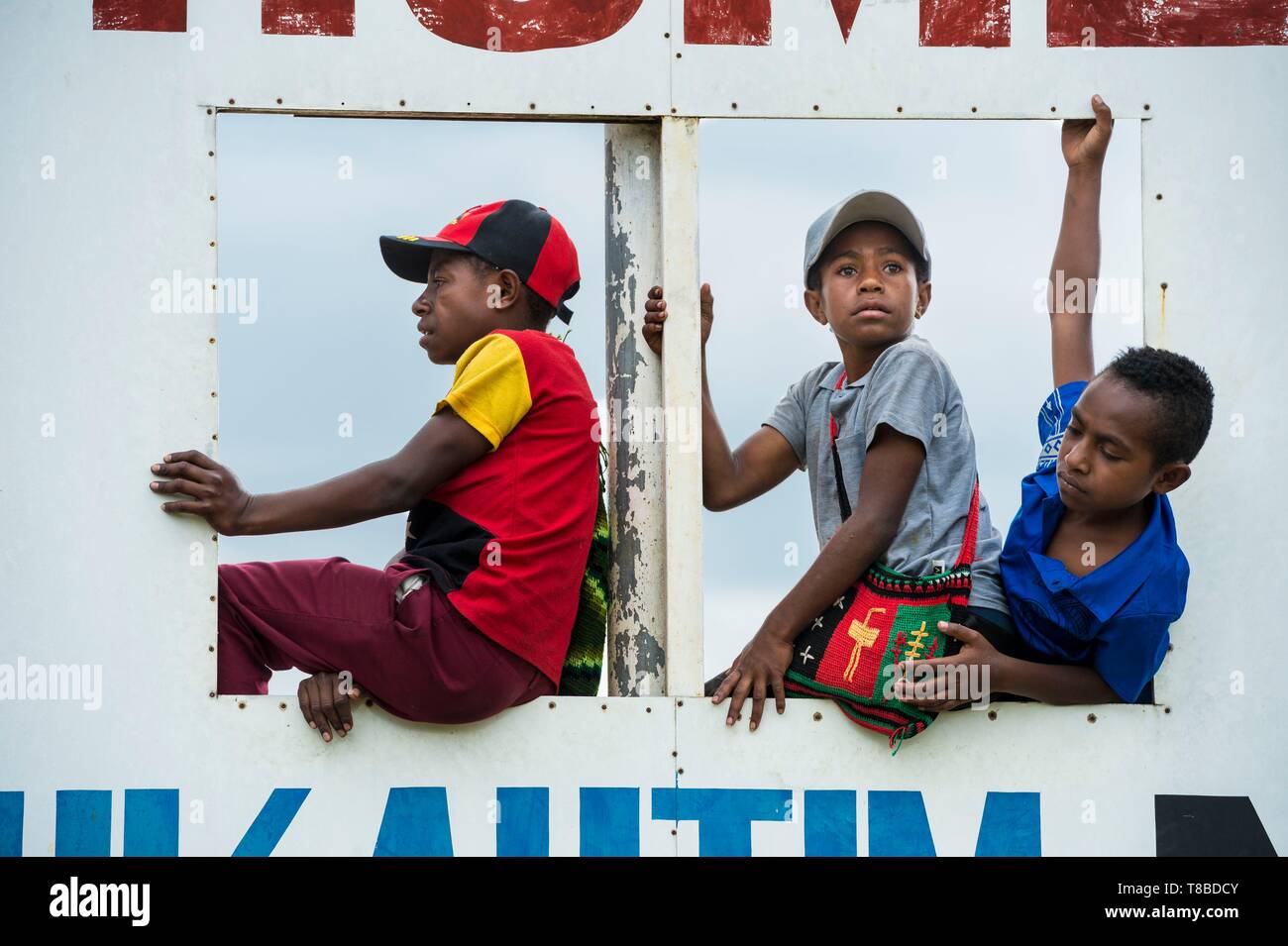 Papua New Guinea, Eastern Highlands Province, Goroka, kids playing in rugby score billboard Stock Photo