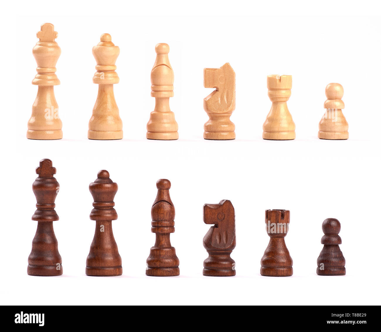 Set of black and white wooden chess figures standing in a row isolated on white background Stock Photo