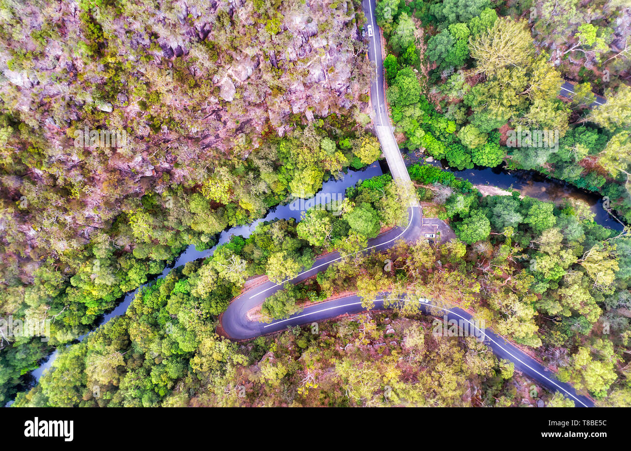 Mountain Galstone road with multiple sharp turns crossing deep creek