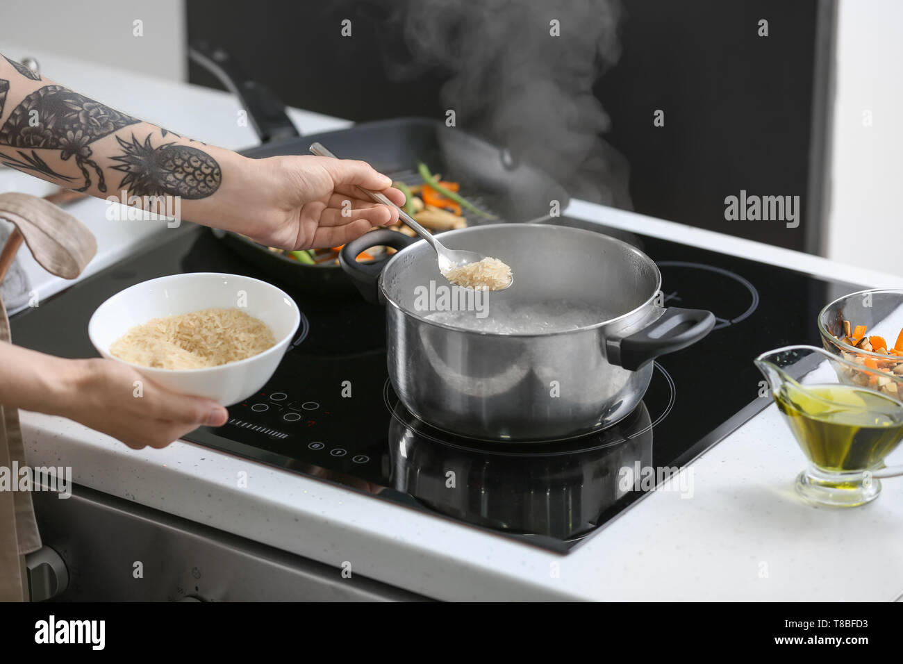 Rice boiling in saucepan hi-res stock photography and images - Alamy