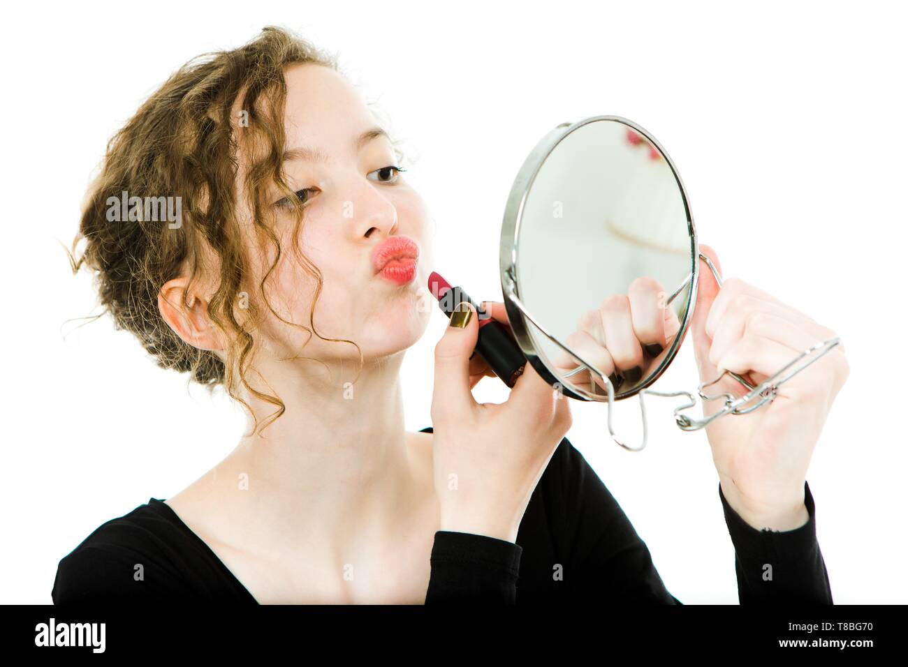 Teen girl applying lipstick hi-res stock photography and images - Alamy