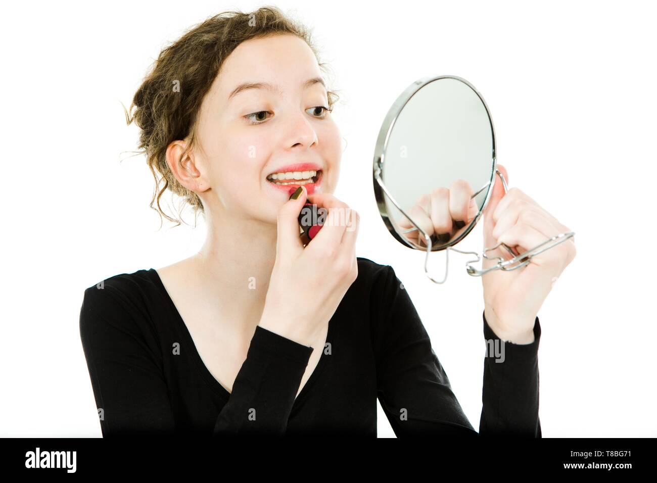 Teenager girl applying lipstick hi-res stock photography and images - Alamy