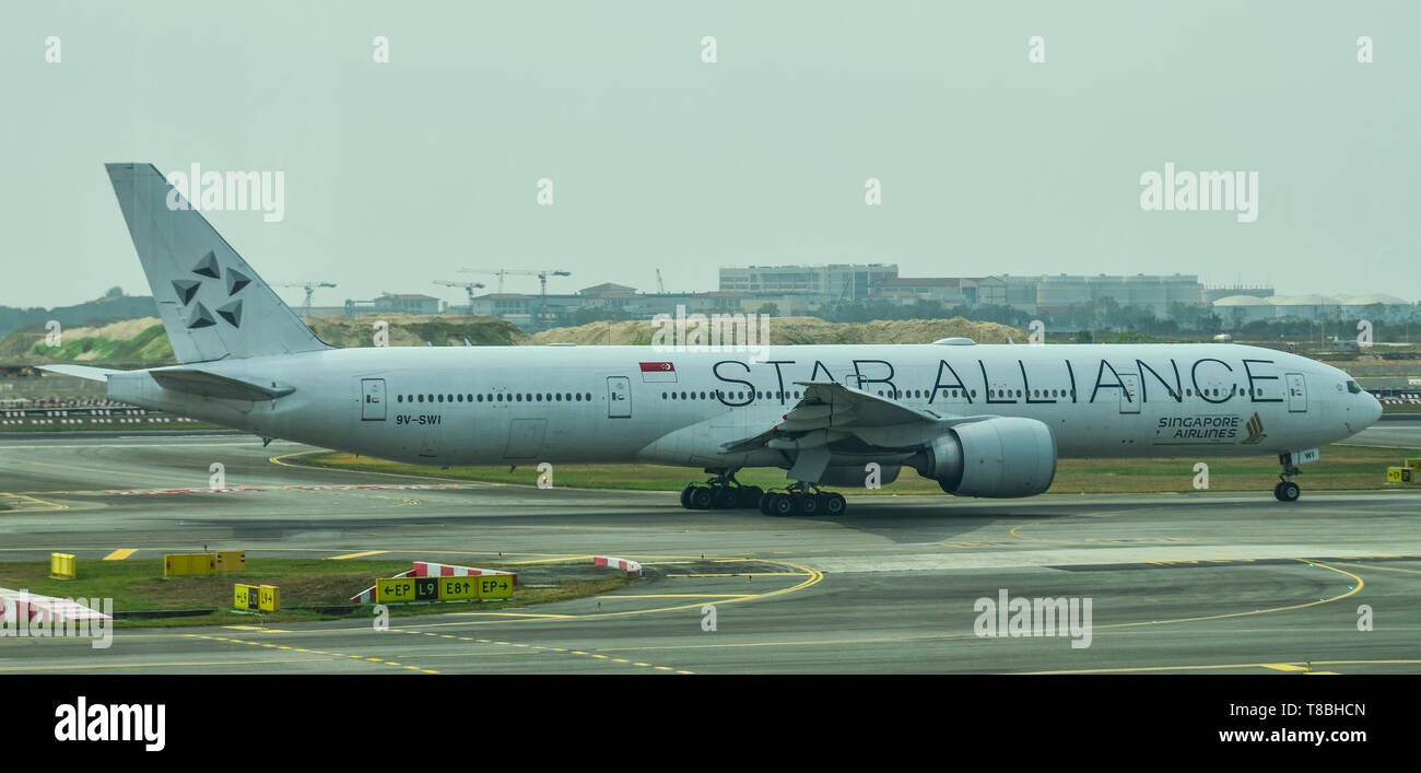 Singapore - Mar 28, 2019. 9V-SWI Singapore Airlines Boeing 777-300ER (White Star Alliance) taxiing on runway of Singapore Changi Airport (SIN). Stock Photo