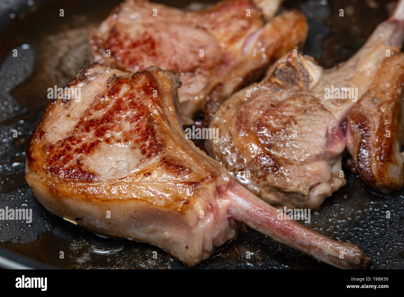 Lamb chops in a frying pan Stock Photo