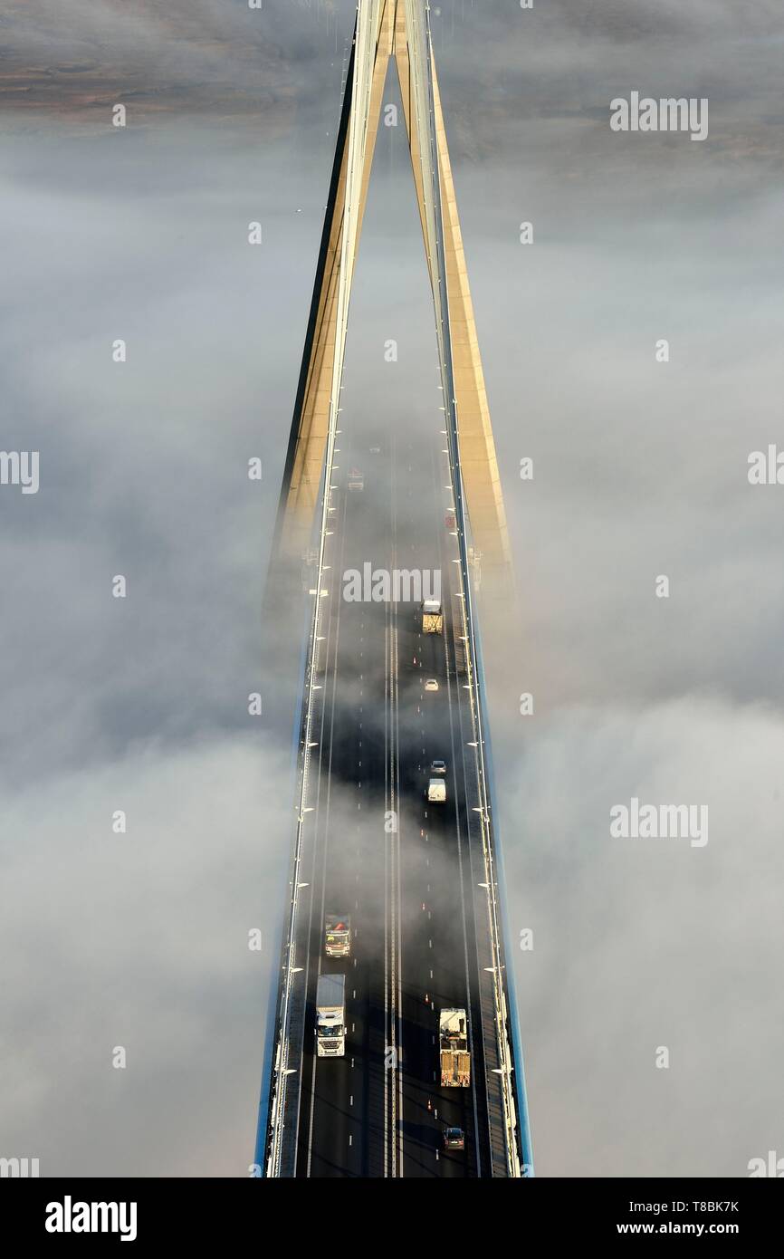 France, between Calvados and Seine Maritime, the Pont de Normandie (Normandy Bridge) that emerges from the morning mist of autumn and spans the Seine, view from the top of the south pylon Stock Photo