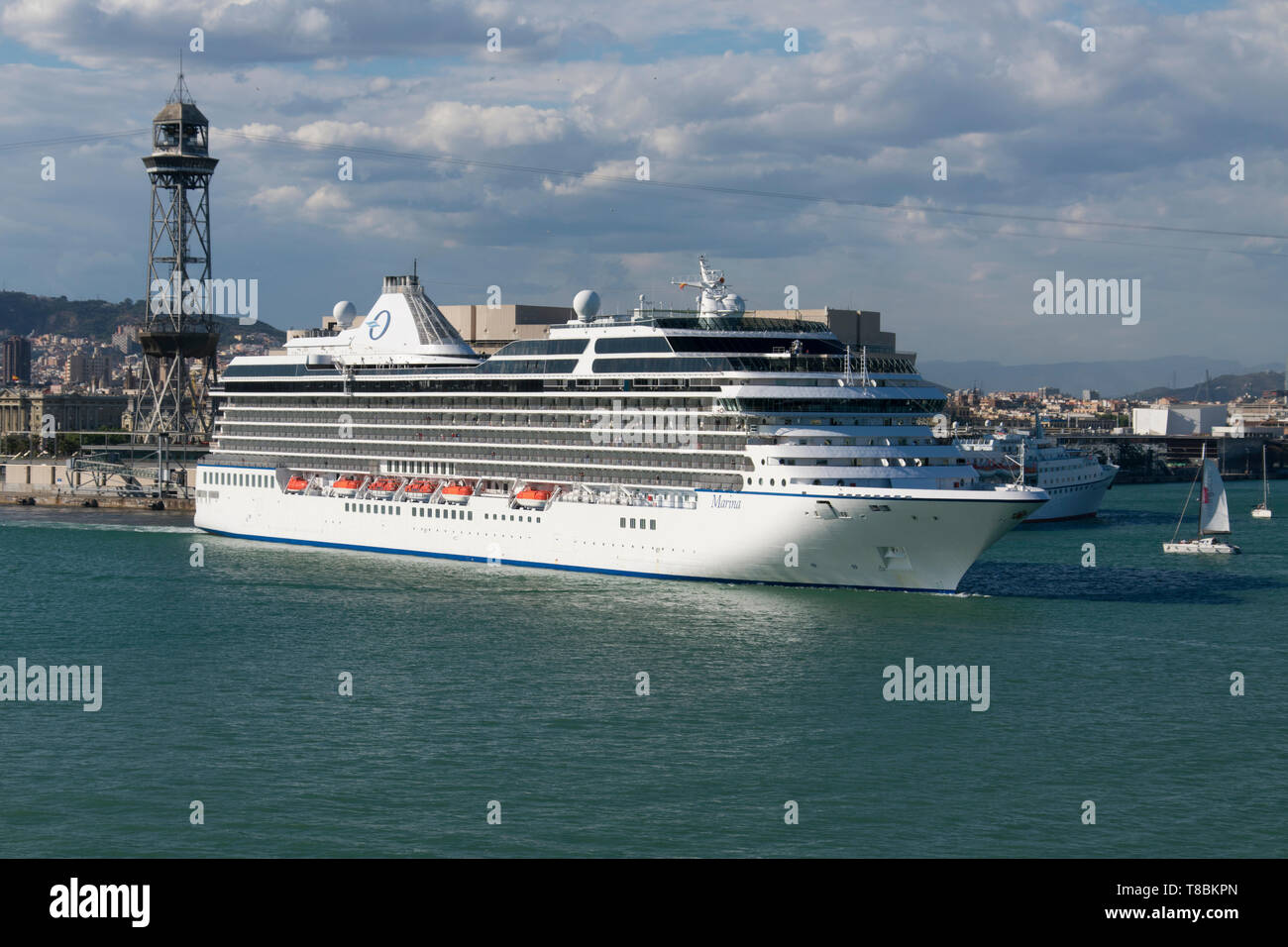 Marine cruise ship of the company Oceania Cruises leaving the port of Barcelona. Stock Photo