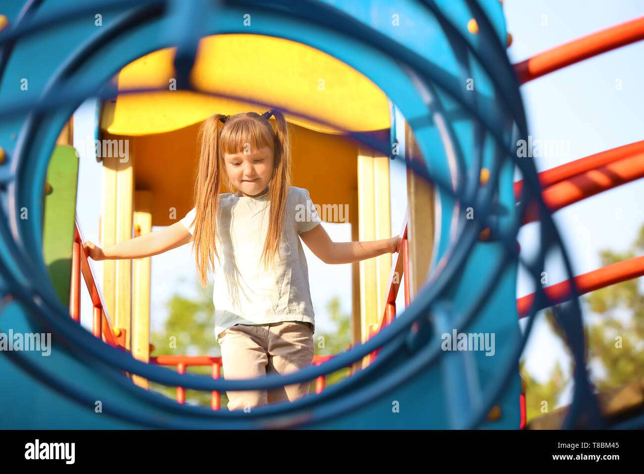 Cute little girl outdoors on playground Stock Photo - Alamy