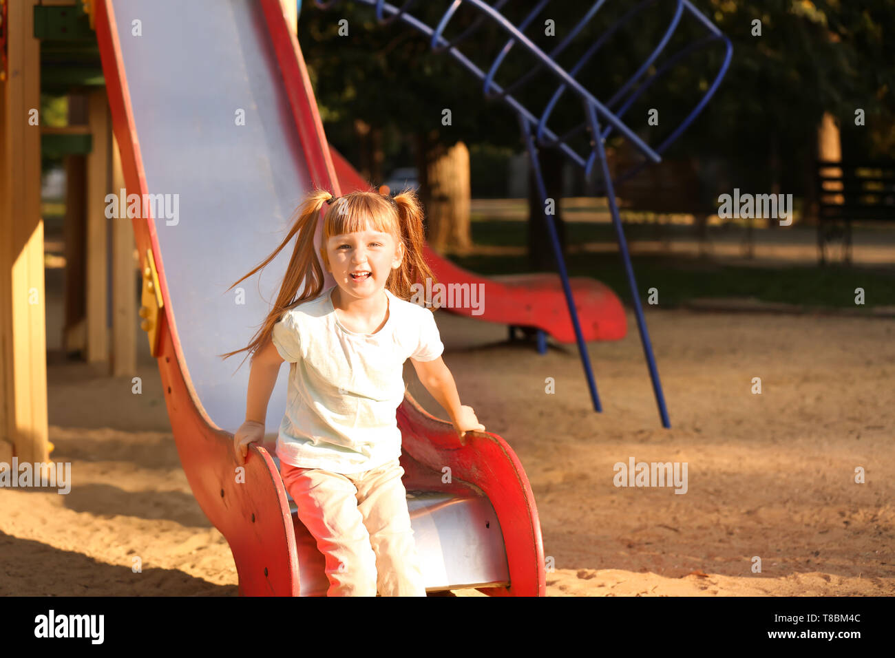Cute little girl outdoors on playground Stock Photo - Alamy