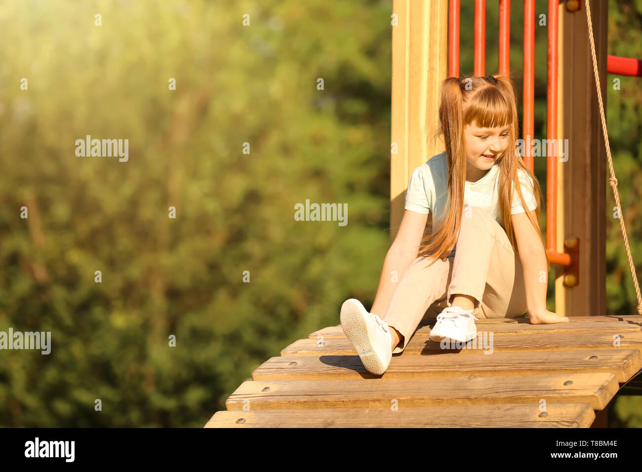 Cute little girl outdoors on playground Stock Photo - Alamy