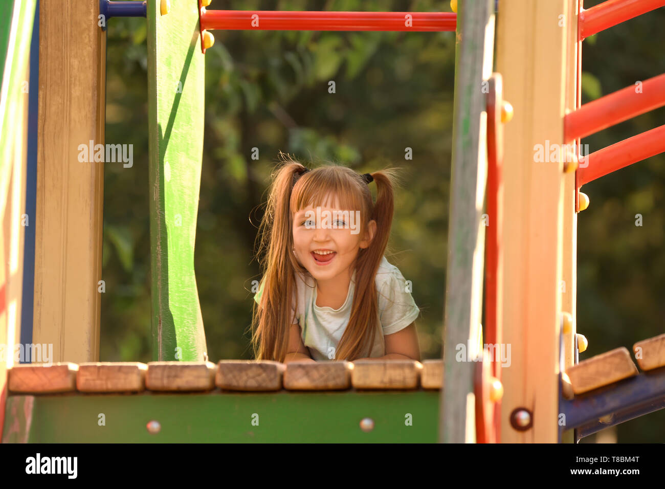 Cute little girl outdoors on playground Stock Photo - Alamy