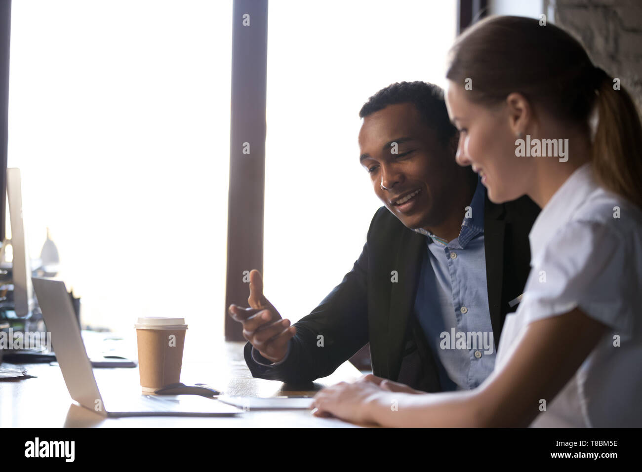 Diverse female coworkers sitting desk hi-res stock photography and ...
