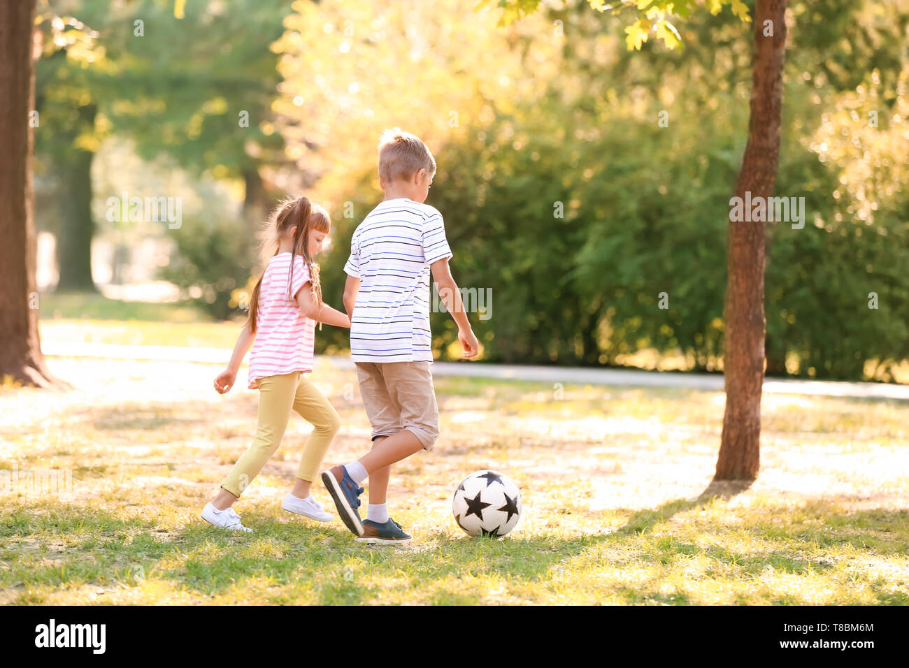 Cute little children playing football outdoors Stock Photo - Alamy