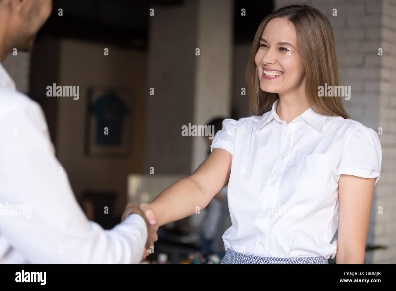 Happy successful female employee receiving from boss congratulations Stock Photo