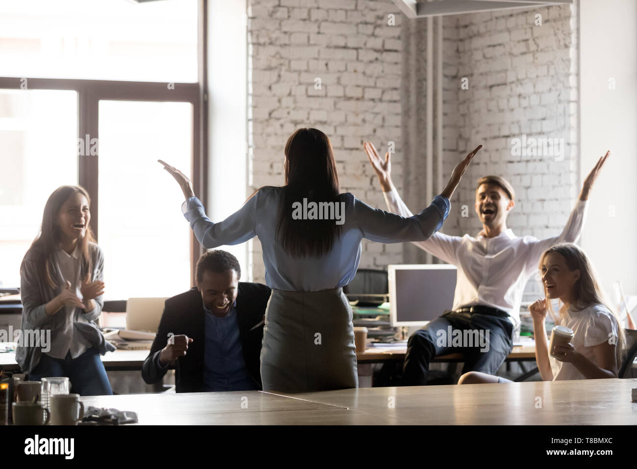 Happy diverse employees celebrating successful accomplishment of project Stock Photo