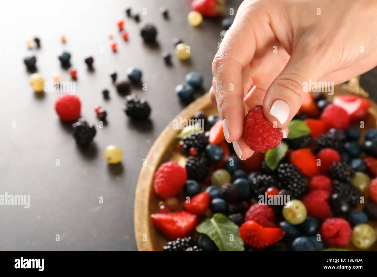 Woman holding raspberry from hi-res stock photography and images - Alamy