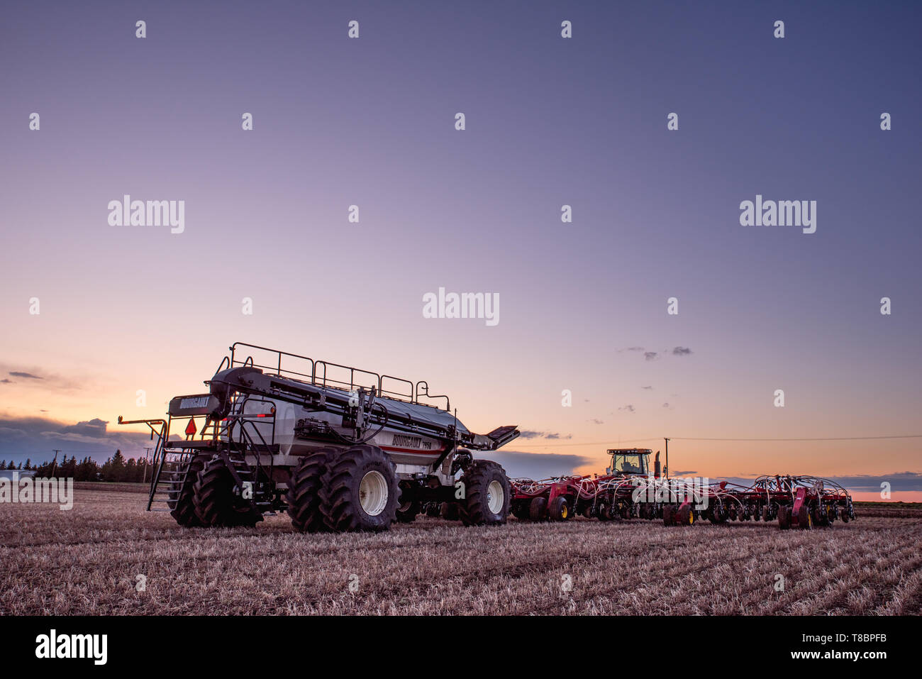 Swift Current, SK/Canada May 10, 2019 Sunset over Caterpillar tractor