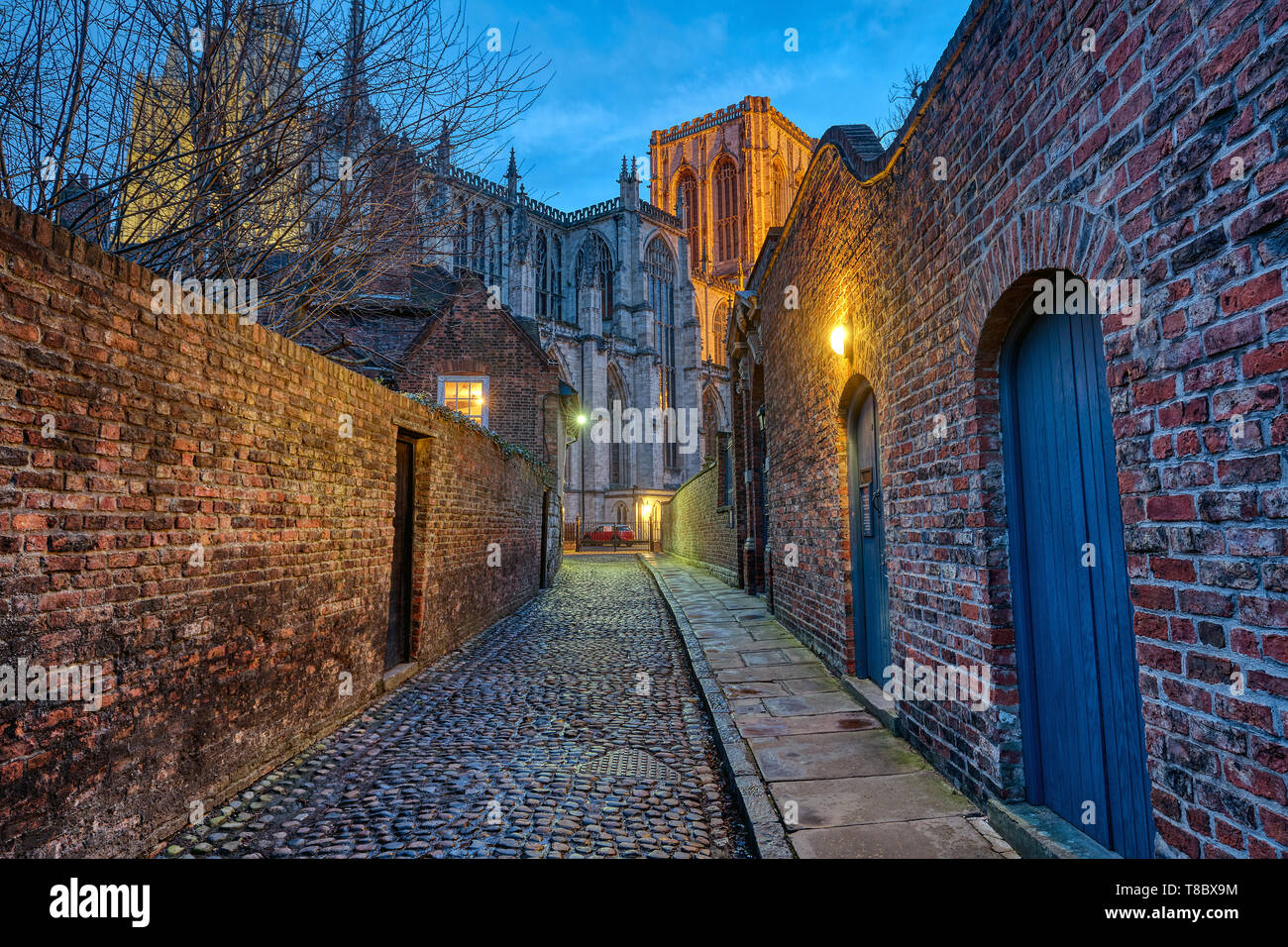 Small cobbled alleyway in York at night with the famous Minster in the back Stock Photo