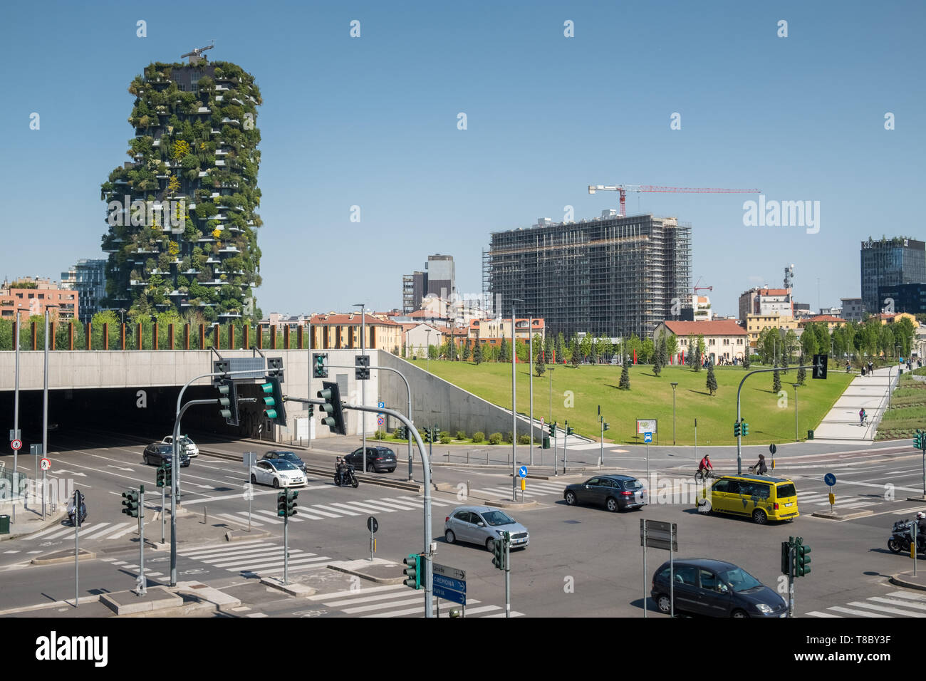 Porta Nuova regeneration street scene at road traffic intersection, with Bosco Verticale apartment buildings in the background, Milan, Italy Stock Photo