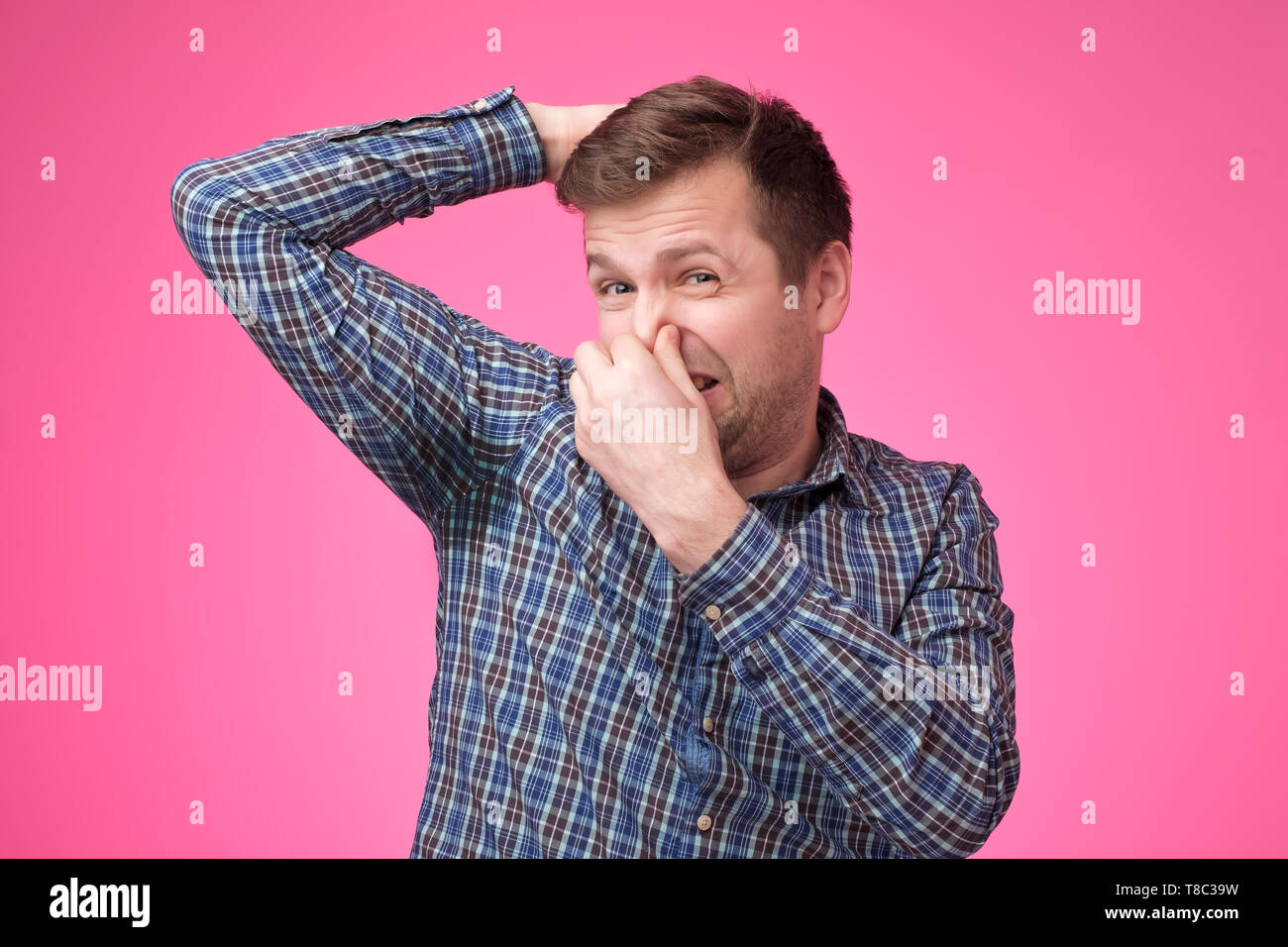 Caucasian, young man is worried and shocked because of sweating stain Stock Photo