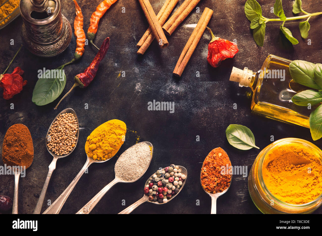 Various herbs and spices on black tin background Stock Photo