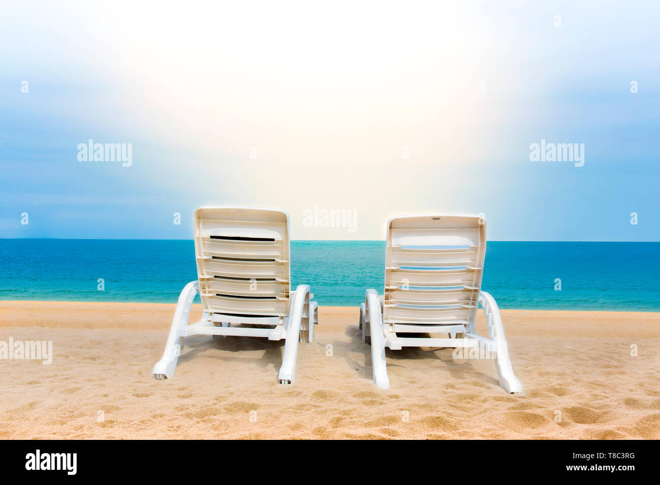 Sand Beach With Coconut Trees With Two Chairs And Bokeh