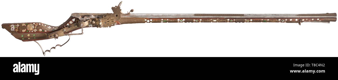 A fine Silesian birding rifle Tschinke, circa 1660-70. With slender octagonal sighted barrel swamped at the muzzle, rifled with six grooves, overlaid with brass panels engraved with leaf and guilloche patterns at the muzzle, the median and the breech, the barrel tang en suite, iron lock of characteristic type almost entirely overlaid with brass panels engraved with stylised flowers 17th century, Additional-Rights-Clearance-Info-Not-Available Stock Photo