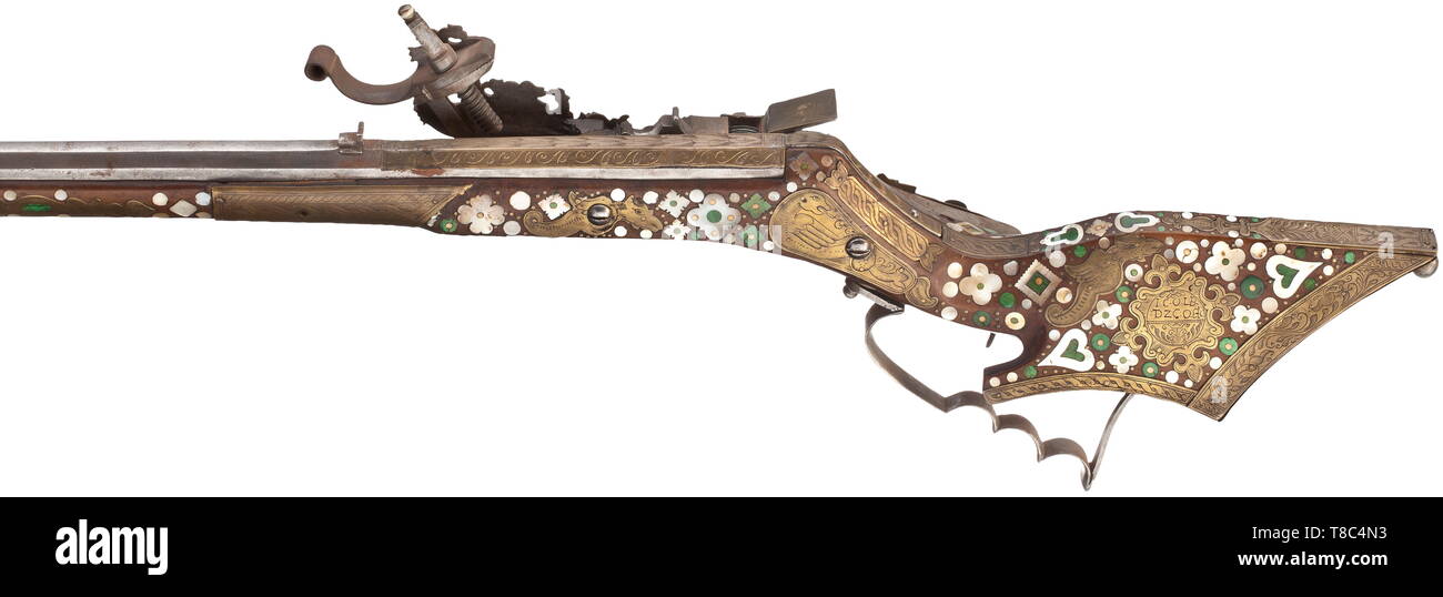A fine Silesian birding rifle Tschinke, circa 1660-70. With slender octagonal sighted barrel swamped at the muzzle, rifled with six grooves, overlaid with brass panels engraved with leaf and guilloche patterns at the muzzle, the median and the breech, the barrel tang en suite, iron lock of characteristic type almost entirely overlaid with brass panels engraved with stylised flowers and foliage, invol 17th century, Additional-Rights-Clearance-Info-Not-Available Stock Photo