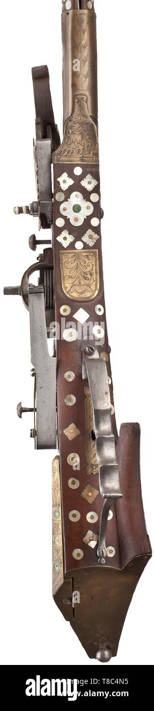 A fine Silesian birding rifle Tschinke, circa 1660-70. With slender octagonal sighted barrel swamped at the muzzle, rifled with six grooves, overlaid with brass panels engraved with leaf and guilloche patterns at the muzzle, the median and the breech, the barrel tang en suite, iron lock of characteristic type almost entirely overlaid with brass panels engraved with stylised flowers 17th century, Additional-Rights-Clearance-Info-Not-Available Stock Photo