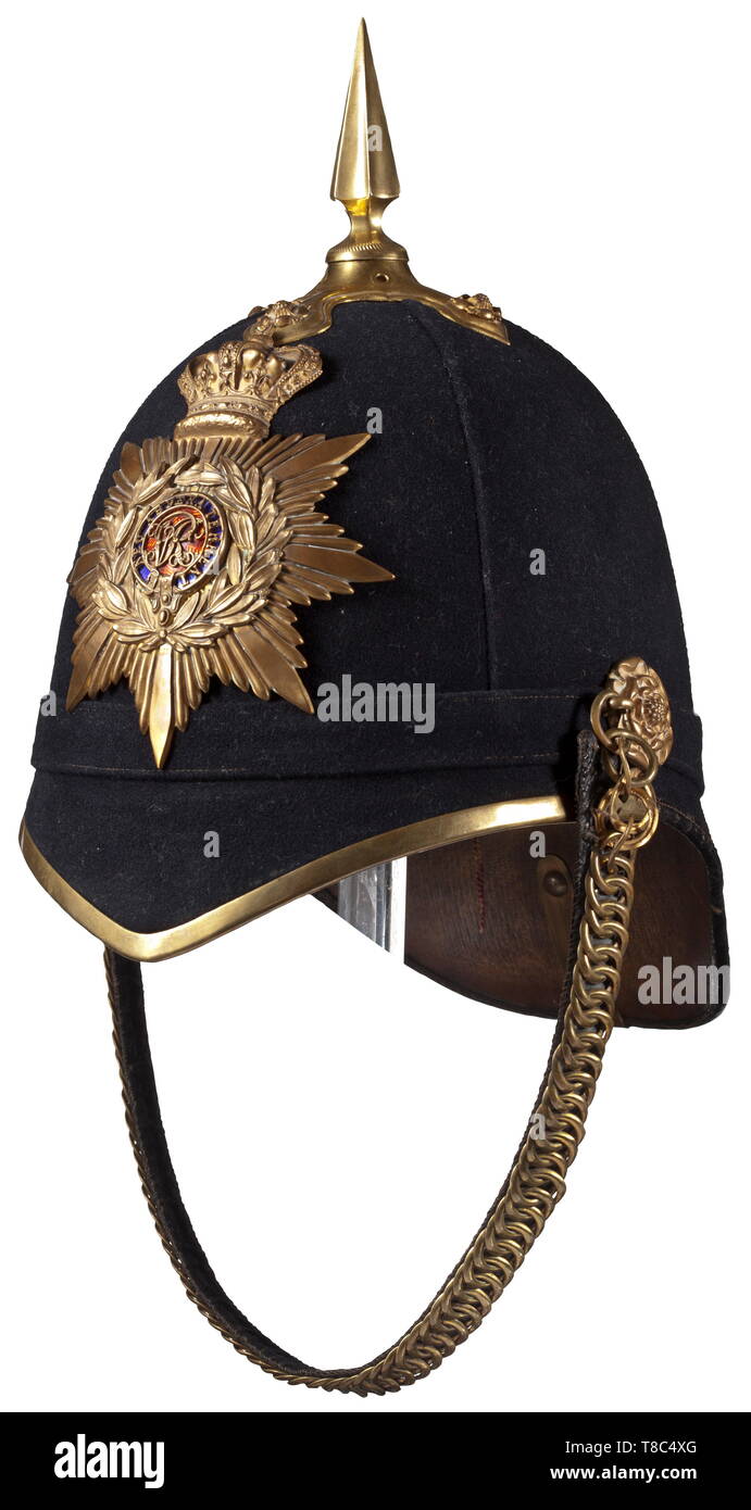 An infantry helmet for officers at the Royal Military College, end of the 19th century Helmet skull covered with black felt, non-ferrous metal fittings (vestiges of gilding), the cross plate with relief-worked roses, screwed-on tip, the emblem with enamelled regimental insignia, velvet-lined chain (ends damaged) on roses in relief. Light cotton liner with red silk edge (damaged), light brown leather sweatband with old size tag '6 3/4' and wearer's tag 'Cripps'. Signs of age. historic, historical, 19th century, Additional-Rights-Clearance-Info-Not-Available Stock Photo