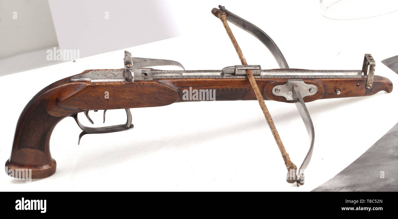 A German pistol crossbow, circa 1840 Forged, slender steel bow with the original string in a screwed guide. Engraved quarrel channel with adjustable rear sight, bolt-clip and folding, also accurately adjustable front sight. Adjustable set trigger. Chequered tiller, iron furniture and grip cap that is engraved en suite. Length 47 cm. historic, historical, crossbow, crossbows, distance weapon, weapons, object, objects, clipping, cut out, cut-out, cut-outs, 19th century, Additional-Rights-Clearance-Info-Not-Available Stock Photo
