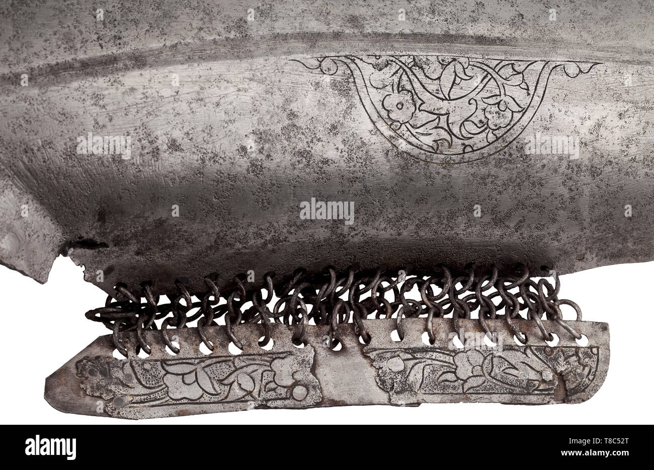 A chamfron, 1st half of the 16th century East Anatolian or Iranian, wrought iron. Grooved edge, with semi-circular chased openings for the eyes and ears. Attached side plates mounted to the centre with four rows of riveted rings. At the forehead large cartouche with engraved scrolling ferns and flowers over cut 'Tamga' of the St. Irene arsenal in Constantinople. In the centre an engraved circular cartouche with a lion passant, the sides and nasal section with floral ornaments. Cleaned condition, some older repairs, small losses, black lacquered i, Additional-Rights-Clearance-Info-Not-Available Stock Photo