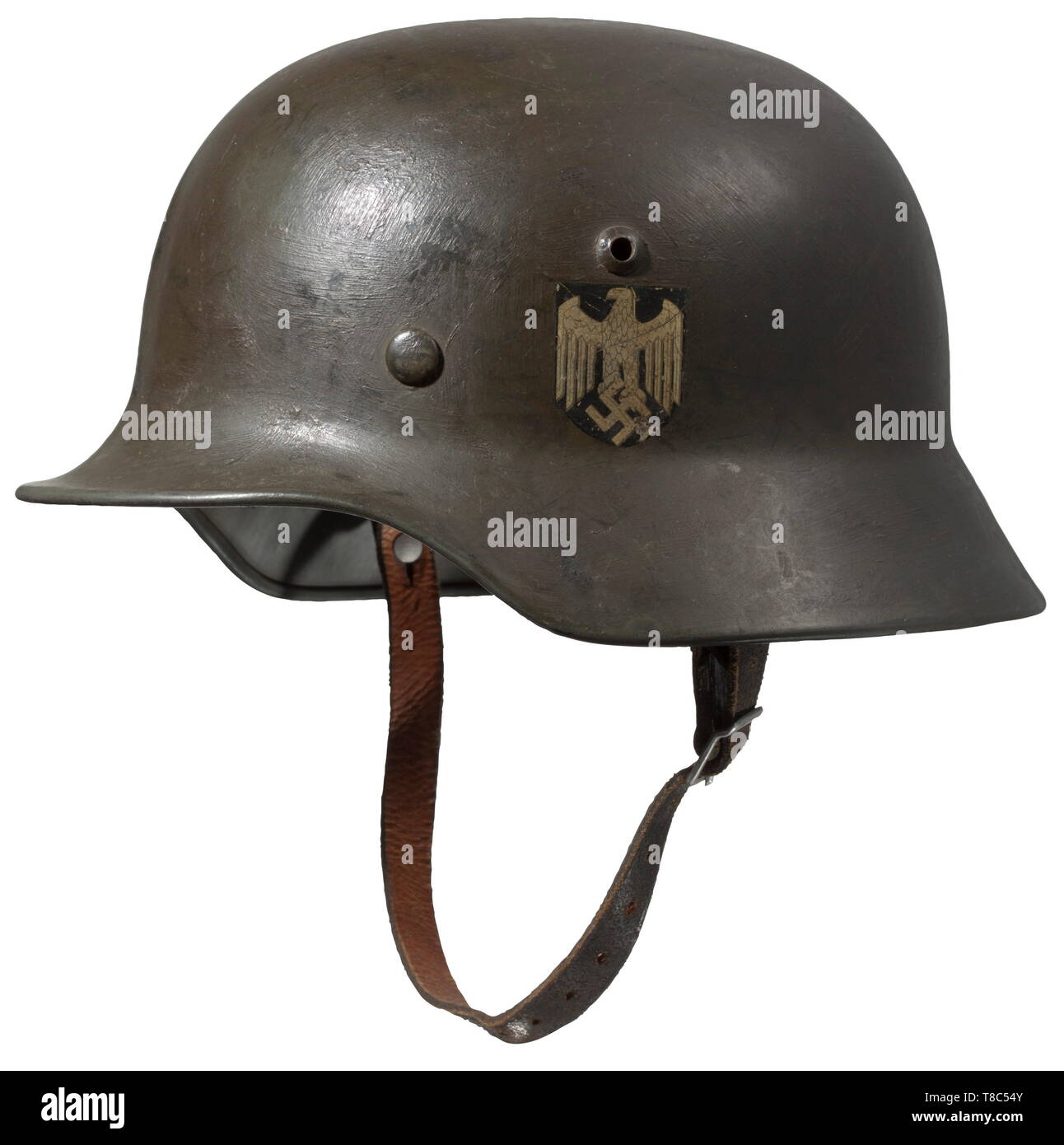 A steel helmet M 35 with both emblems Steel skull with original 'apple-green' base paint, yet somewhat over-coated in the field. Both emblems are almost completely intact. The interior of the helmet control-stamped in 1937. Complete with inner liner (wearer name designation 'Major Kinz') and helmet straps. historic, historical, army, armies, armed forces, military, militaria, 20th century, Editorial-Use-Only Stock Photo