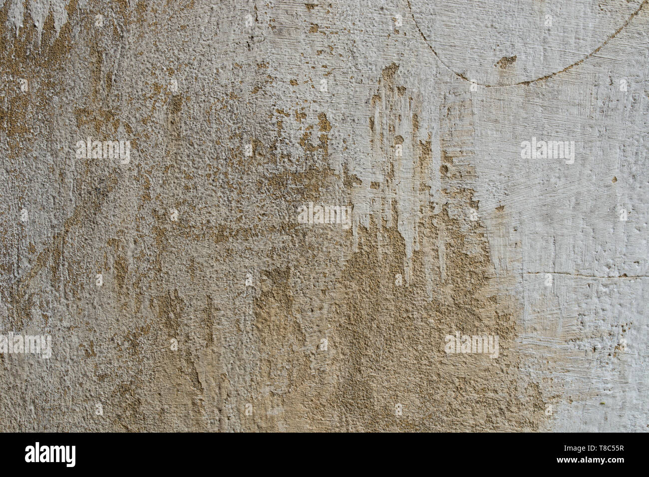 old obsolete beige color plastered wall background texture Stock Photo