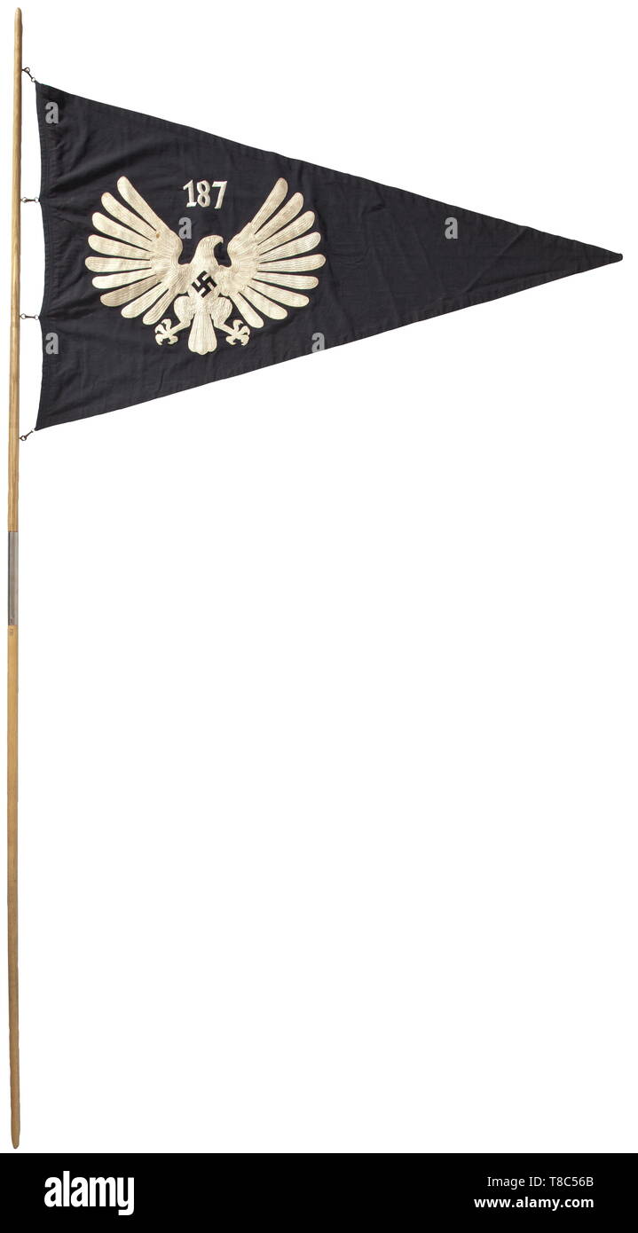 A Young Girls´ League Untergau pennant for Untergau '187' (Ostholstein/Nordmark area) with the rare flagpole, circa 1938 Black navy flag cloth with national eagle on both sides and Untergau number '187' in white chain stitch embroidery. Beautiful condition. Dimensions approximately 76 x 126 cm. The snap hooks corroded. Two-piece flagpole made from oak with RZM marking 'RZM 23/27' above the iron insertion sleeve. Total length 247 cm. Extremely rare. historic, historical, 20th century, 1930s, League of German Girls, Band of German Maidens, youth organization, youth organizati, Editorial-Use-Only Stock Photo