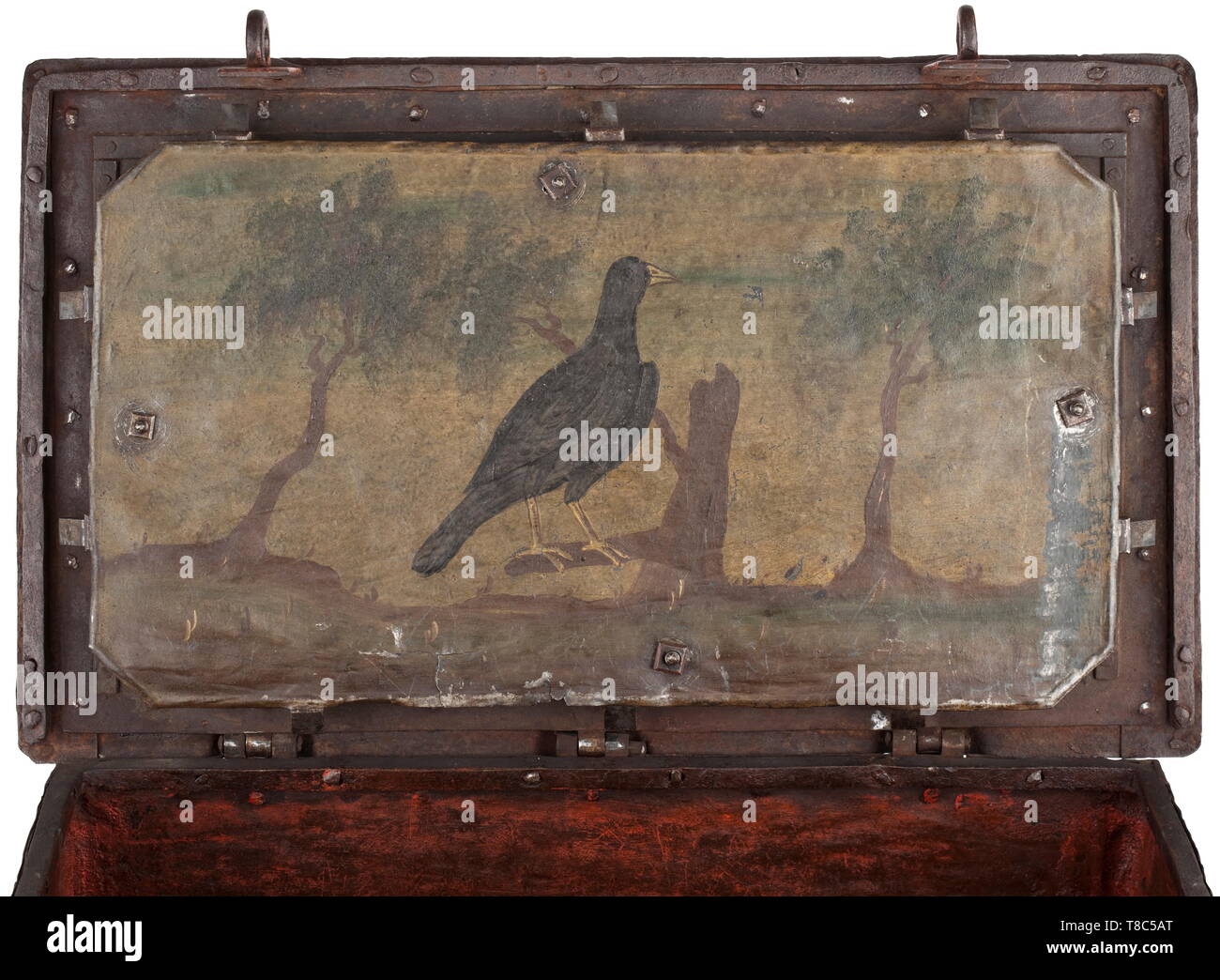 A German strong box, mid-18th century Rectangular body made from sheet iron with broad strap fittings. False keyhole on the front side with large escutcheon in relief. Hinged lid with central keyhole (the key is a replacement). On the inside mechanism with seven latches. Iron cover plate with coloured mounting, depiction of a bird sitting on a branch, flanked by trees. On the front side two hasps for padlocks. Two movable carrying handles on the sides. The bottom with one repair. Dimensions 38 x 65 x 39 cm. historic, historical, handicrafts, hand, Additional-Rights-Clearance-Info-Not-Available Stock Photo