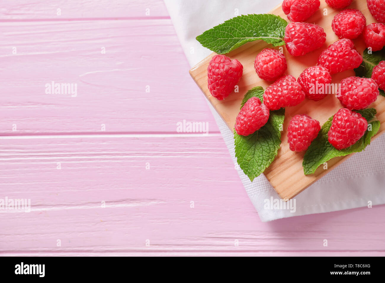 One Raspberry On A Table Wooden board with delicious fresh ripe raspberries on table Stock Photo ...