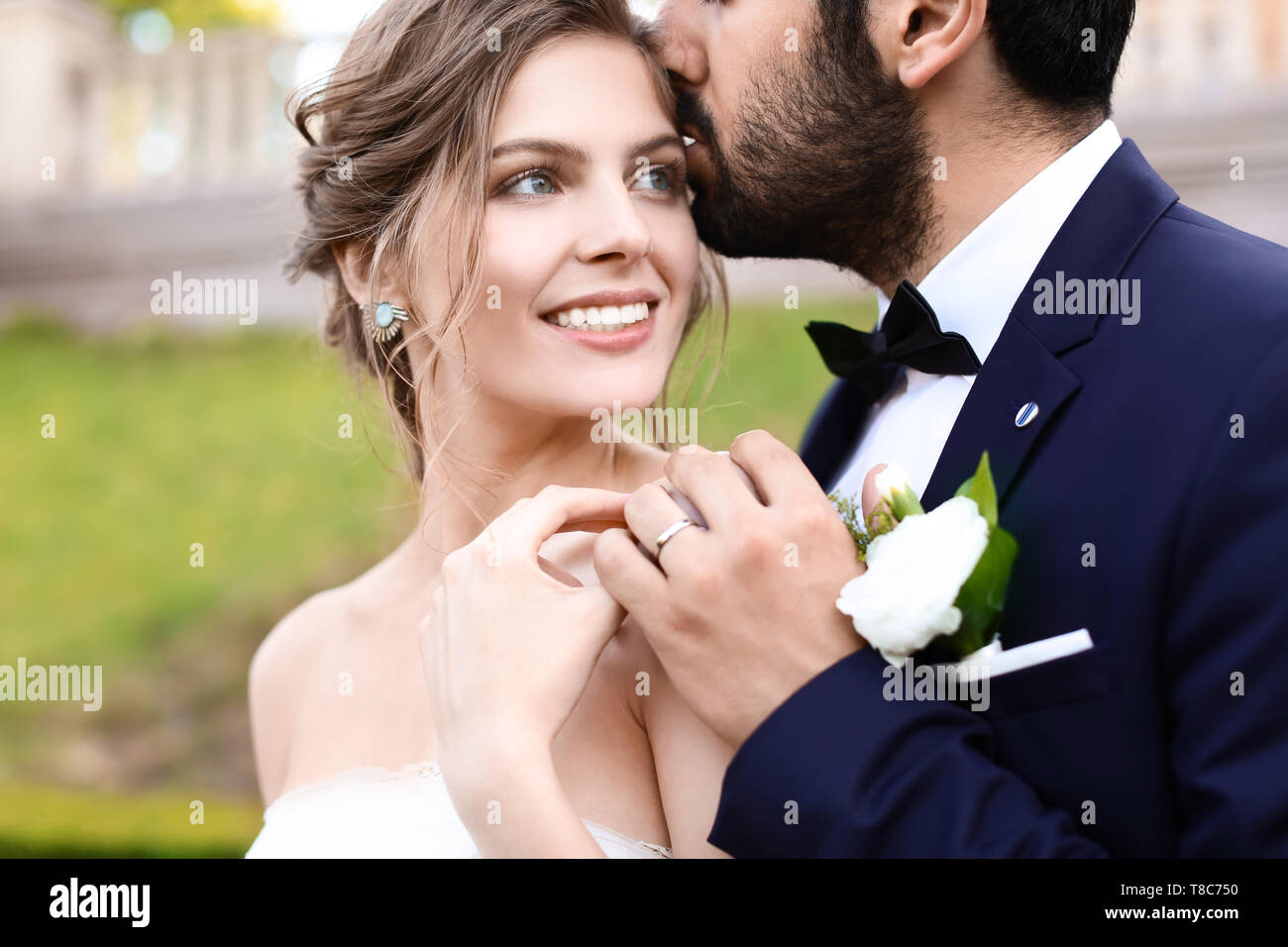 Happy handsome groom kissing hi-res stock photography and images - Alamy