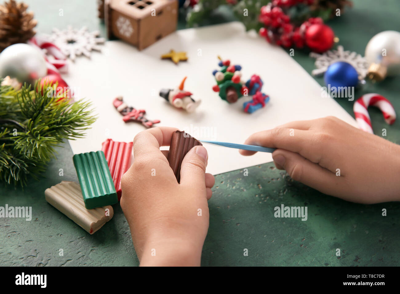 Child Making Christmas Decor From Playdough At Table Stock Photo