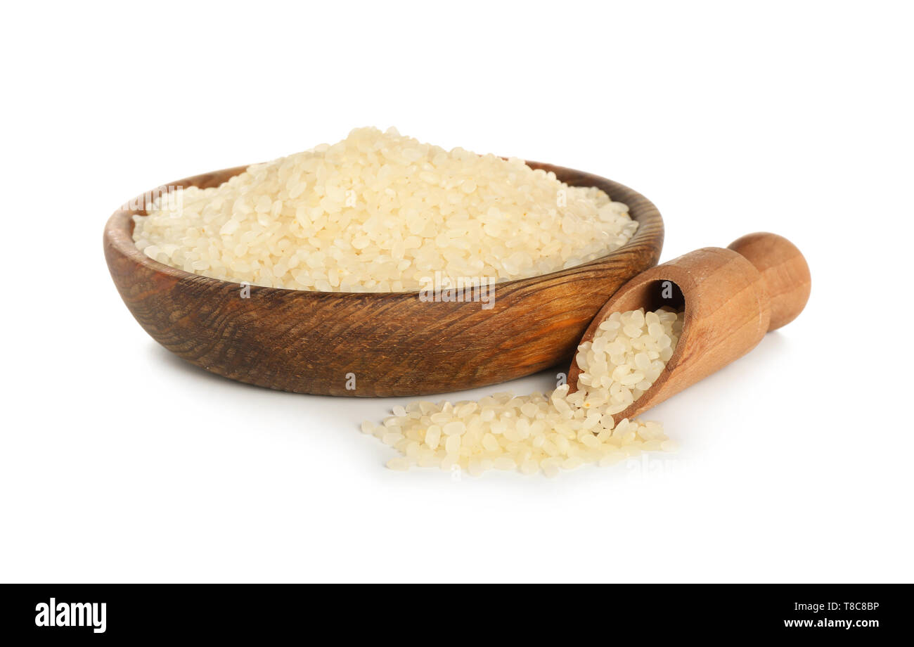 Plate and scoop with raw rice on white background Stock Photo - Alamy
